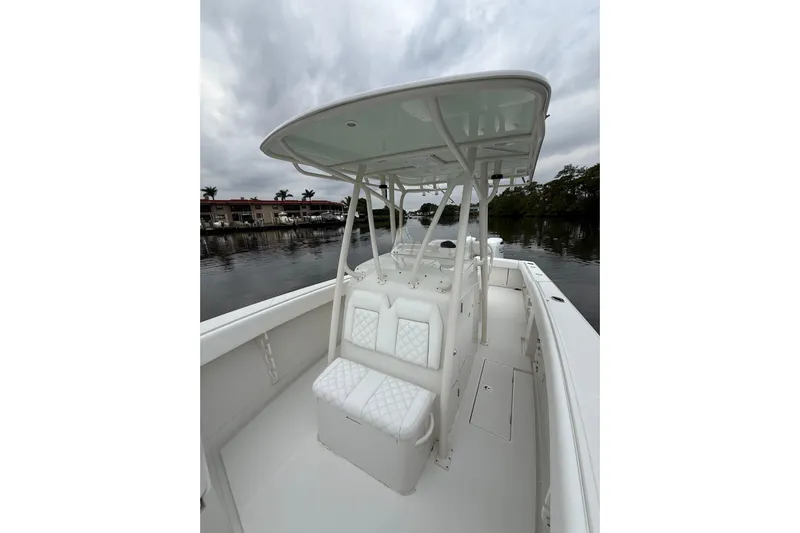  Yacht Photos Pics 2009 Jupiter 29 boat with white seating and canopy on a calm waterway.