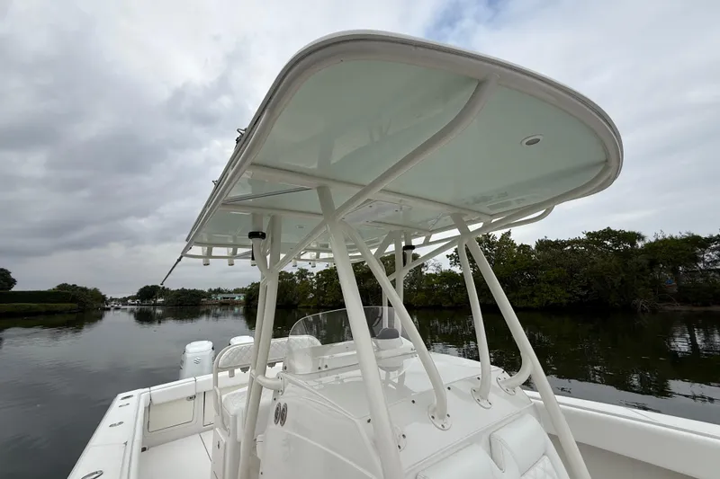  Yacht Photos Pics 2009 Jupiter 29 boat with T-top, docked on a calm river under cloudy skies.