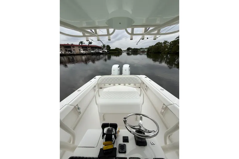  Yacht Photos Pics 2009 Jupiter 29 boat interior with steering wheel, calm water view.