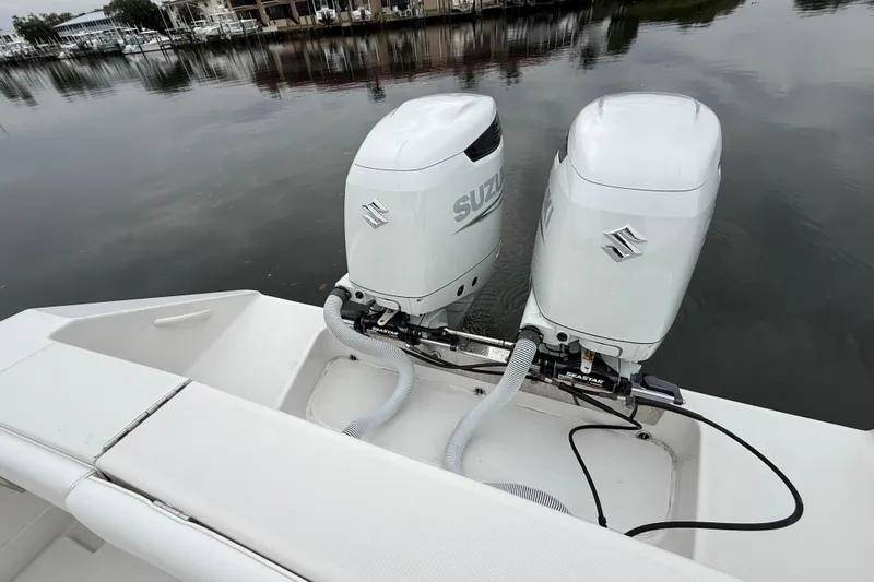  Yacht Photos Pics Twin Suzuki outboard motors on a 2009 Jupiter 29 boat, docked by calm waters.