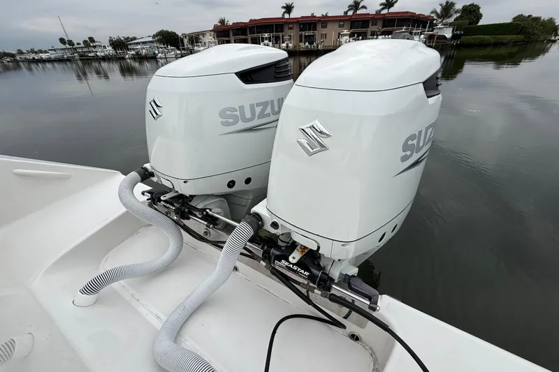  Yacht Photos Pics Twin Suzuki outboard engines on a 2009 Jupiter 29 boat, docked by calm waters.