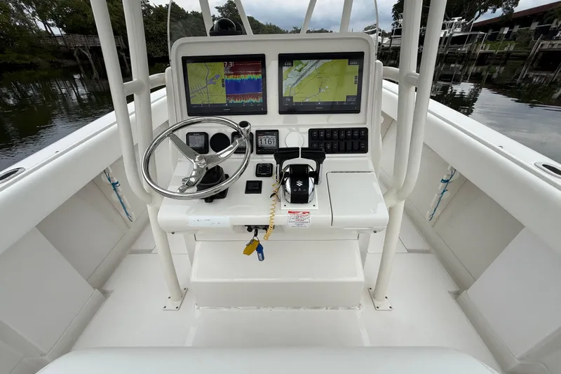  Yacht Photos Pics 2009 Jupiter 29 boat console with navigation screens and steering wheel.