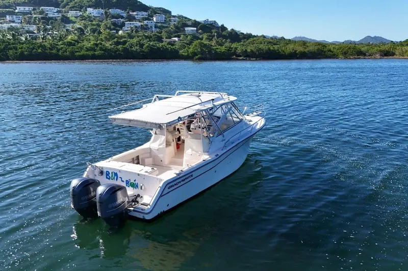  Yacht Photos Pics 2008 Grady-White Express 330 boat on calm water near lush shoreline.
