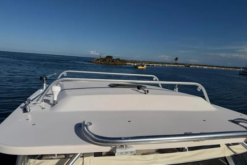  Yacht Photos Pics 2008 Grady-White Express 330 boat on calm water, clear sky, distant shoreline.