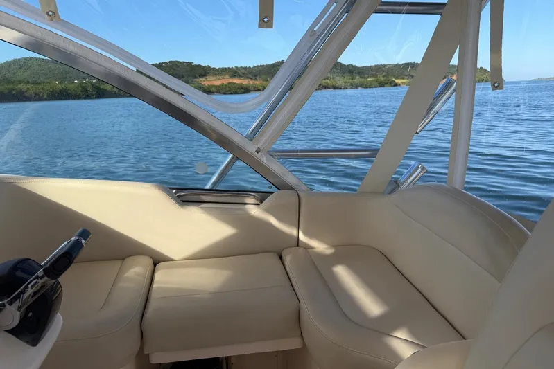  Yacht Photos Pics Interior view of 2008 Grady-White Express 330 boat with comfortable seating and scenic water backdrop.