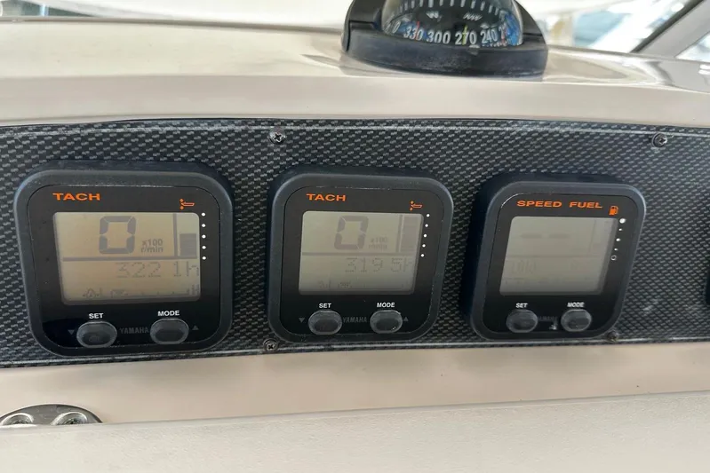  Yacht Photos Pics Dashboard of 2008 Grady-White Express 330 with tachometer and speed fuel gauges.