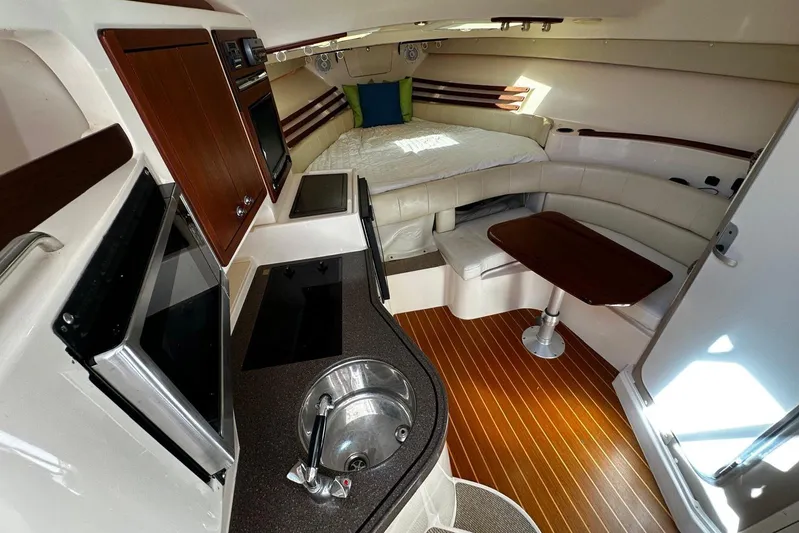 Yacht Photos Pics 2008 Grady-White Express 330 cabin interior with kitchenette, seating, and bed.