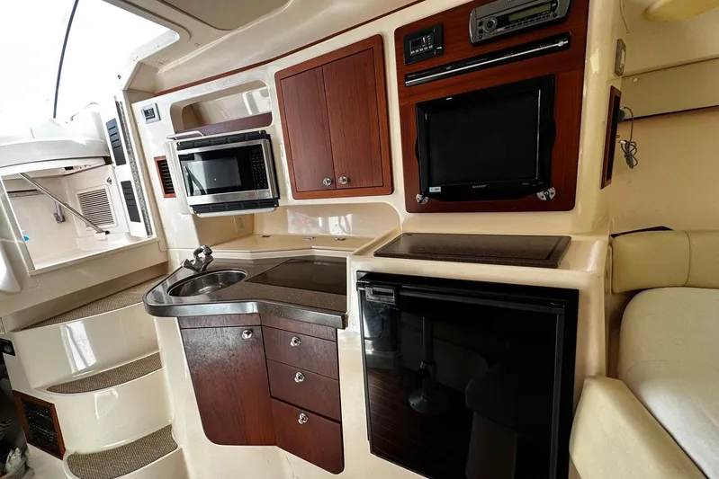  Yacht Photos Pics 2008 Grady-White Express 330 interior with kitchenette, microwave, sink, and TV.