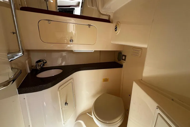  Yacht Photos Pics 2008 Grady-White Express 330 boat bathroom with sink, toilet, and storage cabinet.