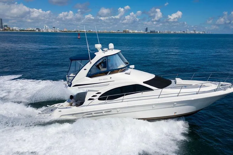 Lazy Days Yacht Photos Pics 2009 Sea Ray 44 Sedan Bridge yacht cruising on open water.