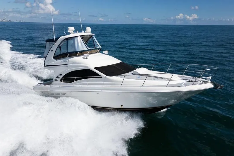 Lazy Days Yacht Photos Pics 2009 Sea Ray 44 Sedan Bridge yacht cruising on open ocean waters.
