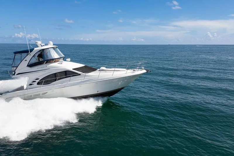 Lazy Days Yacht Photos Pics 2009 Sea Ray 44 Sedan Bridge cruising on open ocean under clear blue sky.