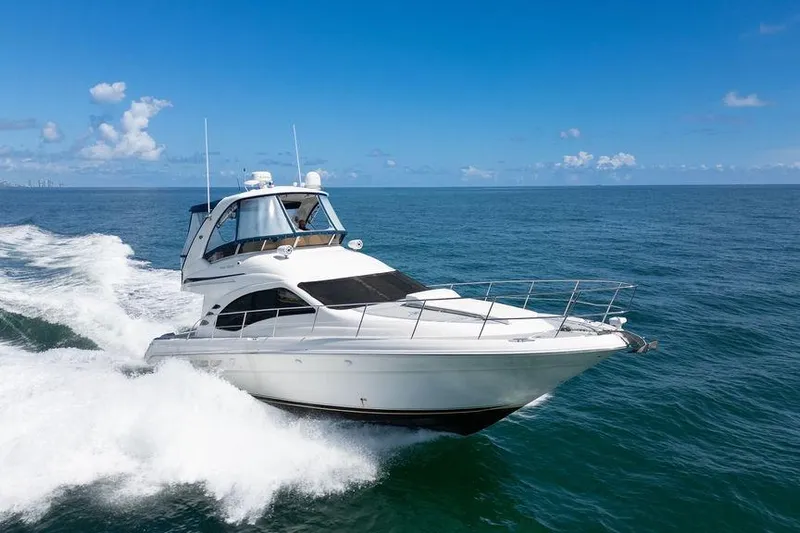 Lazy Days Yacht Photos Pics 2009 Sea Ray 44 Sedan Bridge cruising on open ocean under clear blue sky.