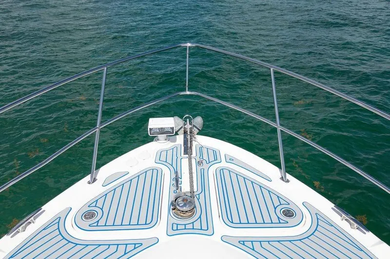 Lazy Days Yacht Photos Pics Bow view of 2009 Sea Ray 44 Sedan Bridge on clear water.