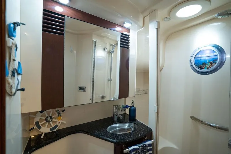 Lazy Days Yacht Photos Pics Luxurious bathroom interior of 2009 Sea Ray 44 Sedan Bridge yacht with porthole and modern fixtures.