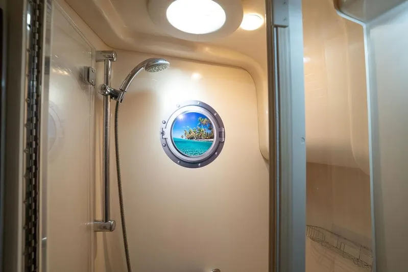 Lazy Days Yacht Photos Pics Shower area in 2009 Sea Ray 44 Sedan Bridge with porthole view.