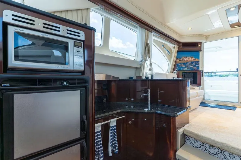 Lazy Days Yacht Photos Pics Luxurious interior of 2009 Sea Ray 44 Sedan Bridge yacht with modern kitchen amenities.