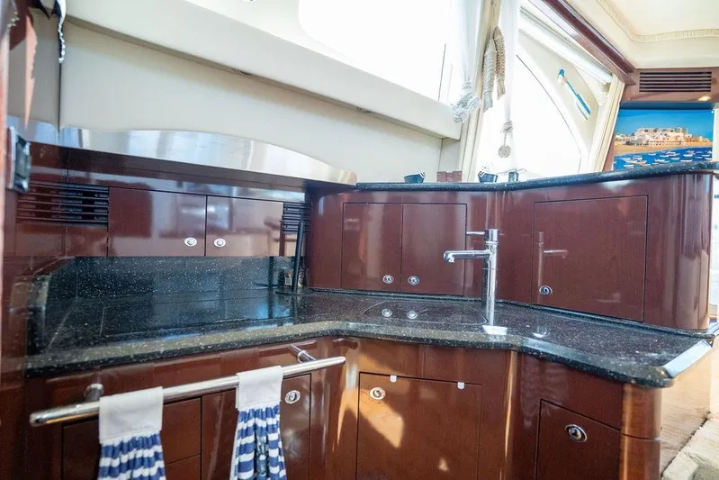 Lazy Days Yacht Photos Pics Luxurious kitchen area in 2009 Sea Ray 44 Sedan Bridge yacht with sleek cabinetry.