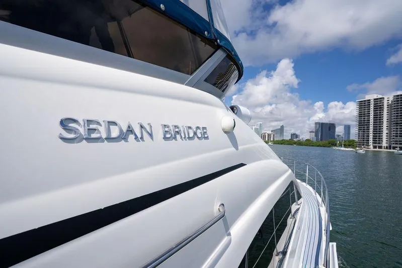 Lazy Days Yacht Photos Pics 2009 Sea Ray 44 Sedan Bridge yacht cruising near city skyline.