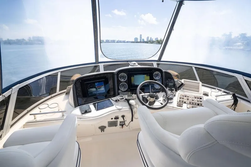 Lazy Days Yacht Photos Pics 2009 Sea Ray 44 Sedan Bridge helm with modern navigation equipment and panoramic water view.