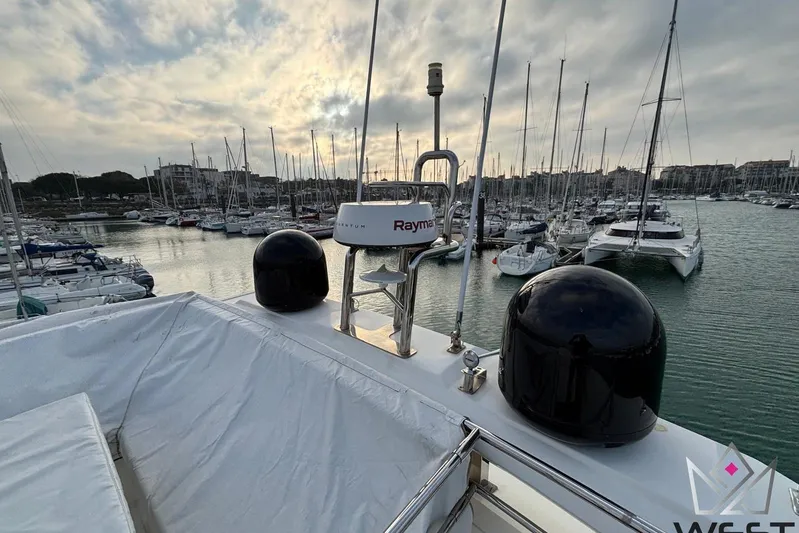 Albina Yacht Photos Pics 2018 Prestige 520 yacht docked in a marina with sailboats and cloudy sky.
