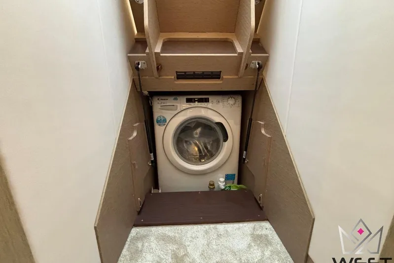 Albina Yacht Photos Pics Compact laundry area in a 2018 Prestige 520, featuring a Candy washing machine.