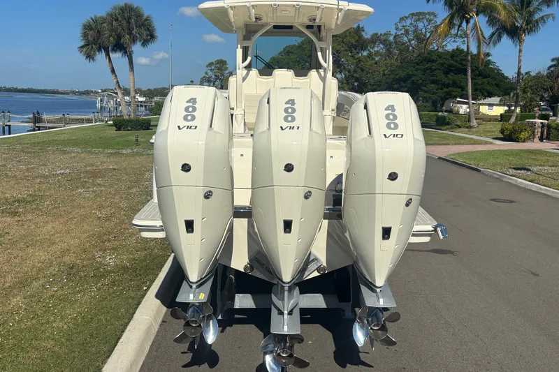  Yacht Photos Pics 2026 Scout 357 LXF boat with triple Mercury 400 V10 engines, parked near waterfront.