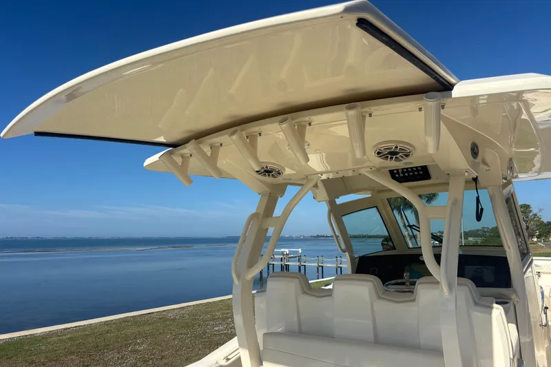  Yacht Photos Pics 2026 Scout 357 LXF boat with sleek design and advanced features by the water.