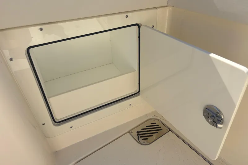  Yacht Photos Pics Open storage compartment on 2026 Scout 357 LXF boat, featuring a secure latch and drainage.