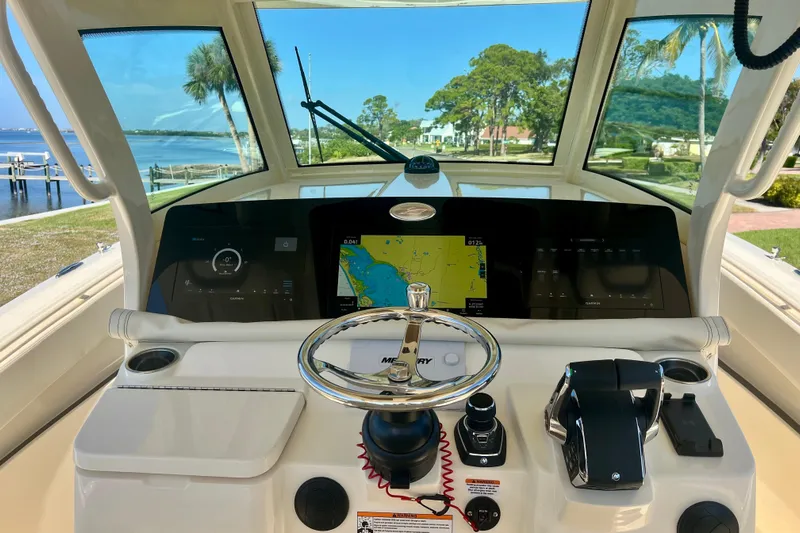  Yacht Photos Pics 2026 Scout 357 LXF boat dashboard with navigation screens and steering wheel.