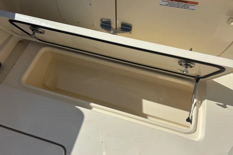  Yacht Photos Pics Open storage compartment on 2026 Scout 357 LXF boat, showcasing interior space.