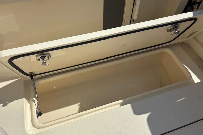  Yacht Photos Pics Open storage compartment on 2026 Scout 357 LXF boat, showcasing interior space.