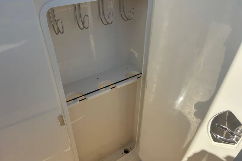 Yacht Photos Pics Storage compartment inside 2026 Scout 357 LXF boat, featuring hooks and cup holders.