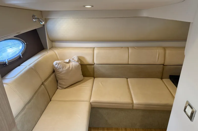 Another Six Pack Yacht Photos Pics 2016 Formula 37 Performance Cruiser interior with beige leather seating and porthole window.