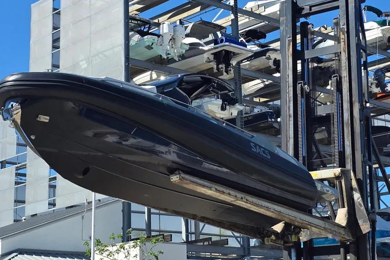 B-offline Yacht Photos Pics 2019 SACS Rebel 40 boat lifted by forklift in marina storage facility.