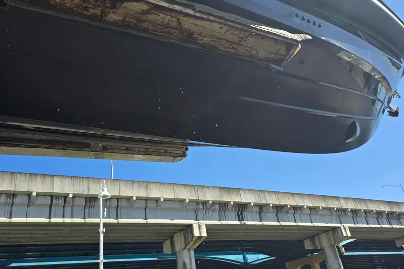 B-offline Yacht Photos Pics 2019 SACS Rebel 40 boat hull under a bridge, clear blue sky.