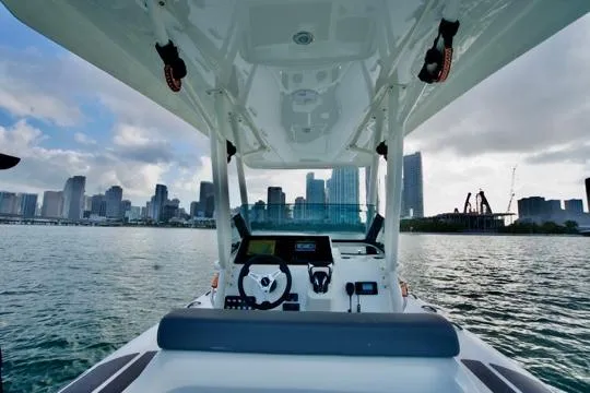  Yacht Photos Pics 2022 Brig Eagle 10 boat navigating near city skyline on a sunny day.