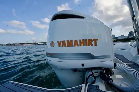  Yacht Photos Pics Outboard motor on 2022 Brig Eagle 10 boat, ocean backdrop, clear sky.