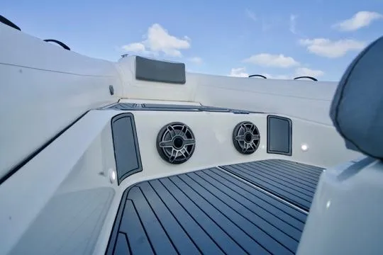  Yacht Photos Pics 2022 Brig Eagle 10 boat interior with speakers and cushioned seating under a blue sky.