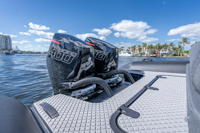  Yacht Photos Pics Twin outboard engines on a 2024 Goldfish X10 Scout boat, docked by a marina.