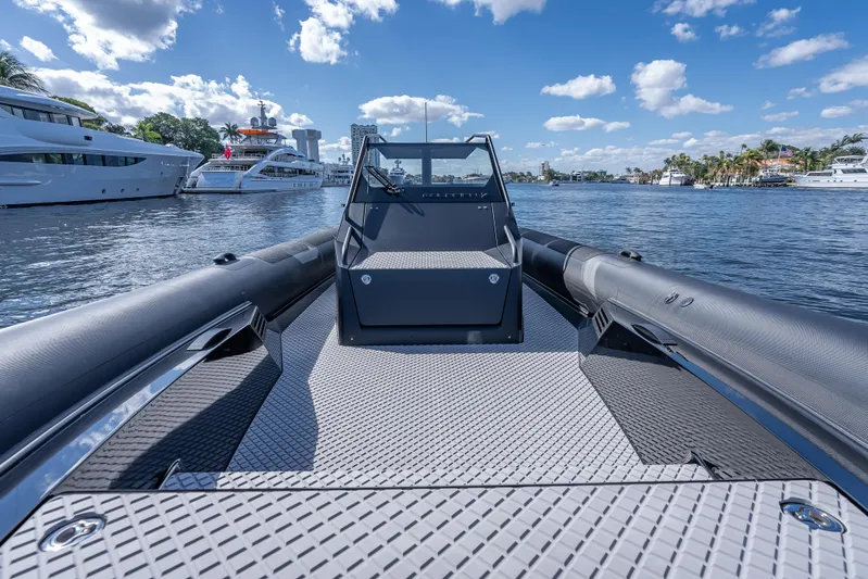  Yacht Photos Pics 2024 Goldfish X10 Scout boat on water with yachts in the background.