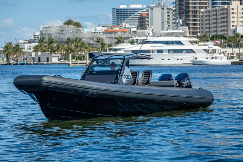  Yacht Photos Pics 2024 Goldfish X10 Scout boat on water with cityscape background.