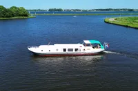 Aerial view of a vintage 1958 custom boat cruising on a serene lake.