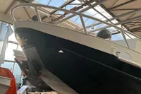 Custom 1958 boat in a warehouse, showcasing sleek design and sturdy construction.