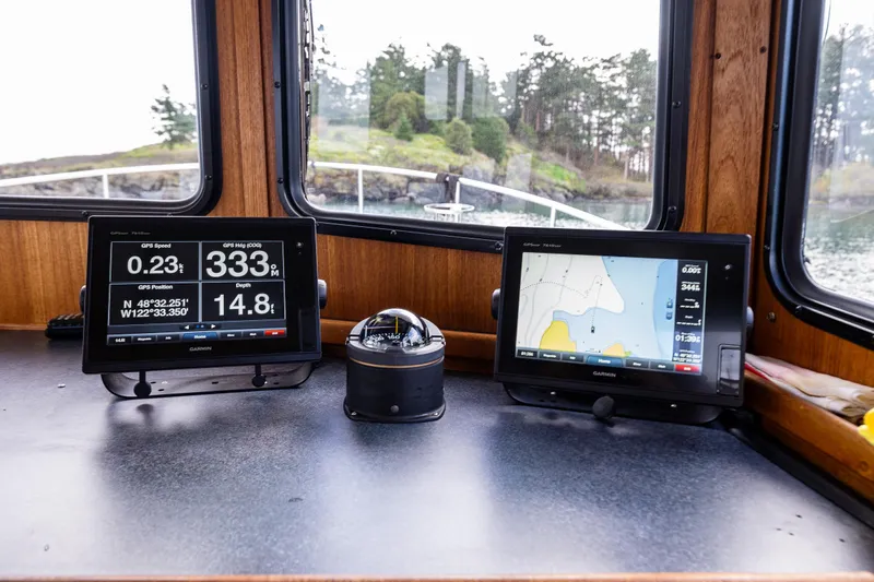 Artemis Yacht Photos Pics Navigation equipment on 1999 Nordic Tug 32 boat, featuring Garmin displays and compass.