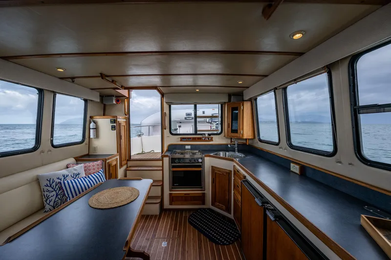 Artemis Yacht Photos Pics Interior of 1999 Nordic Tug 32 with kitchen, dining area, and ocean view.