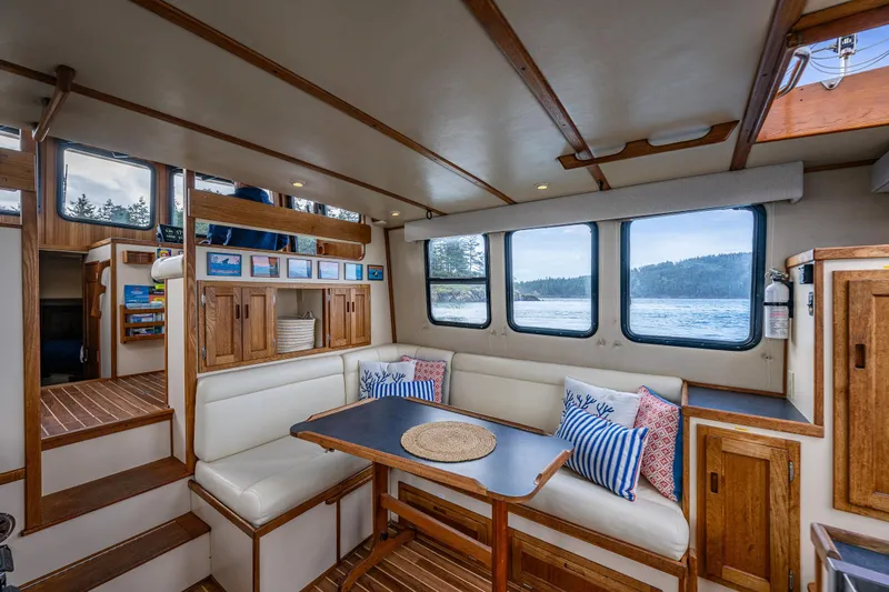 Artemis Yacht Photos Pics Interior of 1999 Nordic Tug 32 with cozy seating and scenic window views.