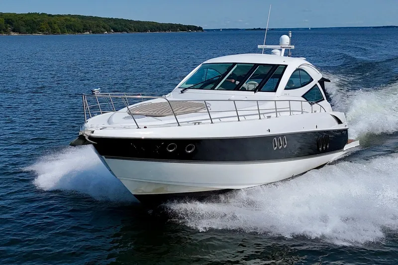  Yacht Photos Pics 2012 Cruisers Yachts 540 Sports Coupe cruising on open water.