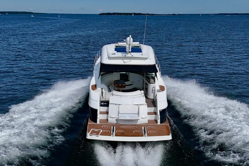  Yacht Photos Pics 2012 Cruisers Yachts 540 Sports Coupe cruising on open water, rear view.