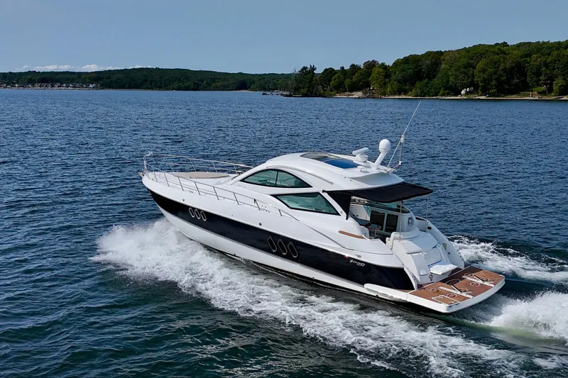  Yacht Photos Pics 2012 Cruisers Yachts 540 Sports Coupe cruising on a scenic lake.